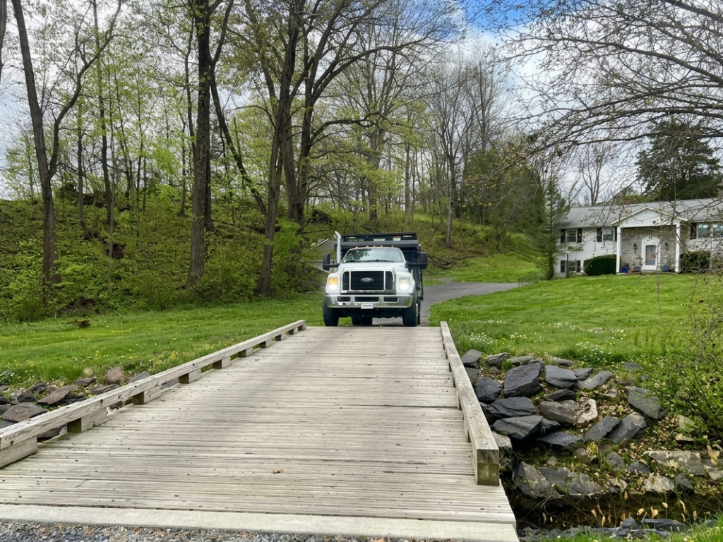 A Dotterer Disposal truck crossing a bridge