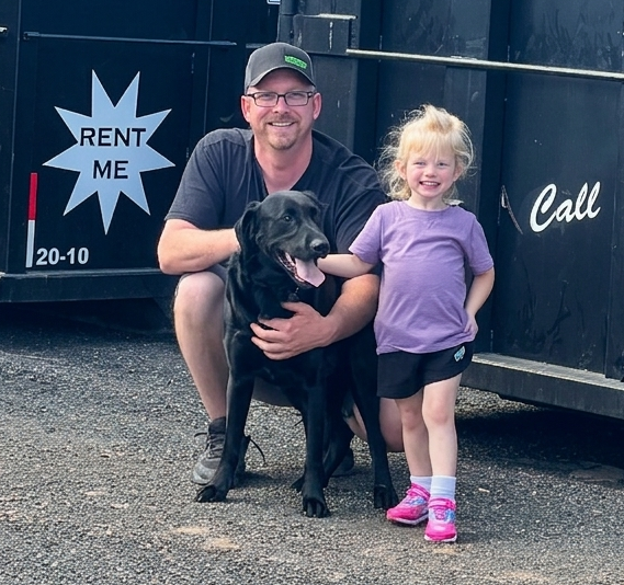 Isaac Dotterer with a black lab and female child